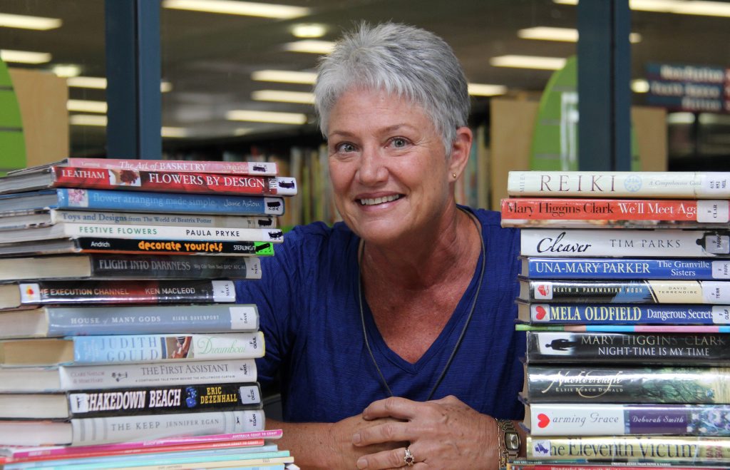 FOILS member, Karalee resident Darcy Otjen, gets books ready for the charity sale. FOILS member, Karalee resident Darcy Otjen, gets books ready for the charity sale.